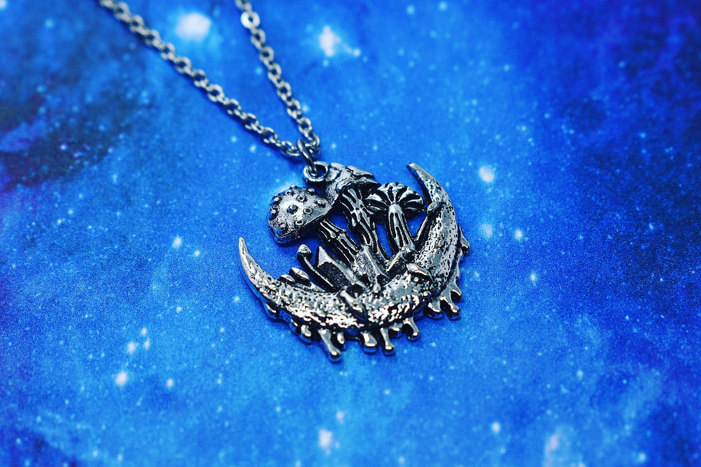 Necklace with crescent moon, mushroom and crystal pendant