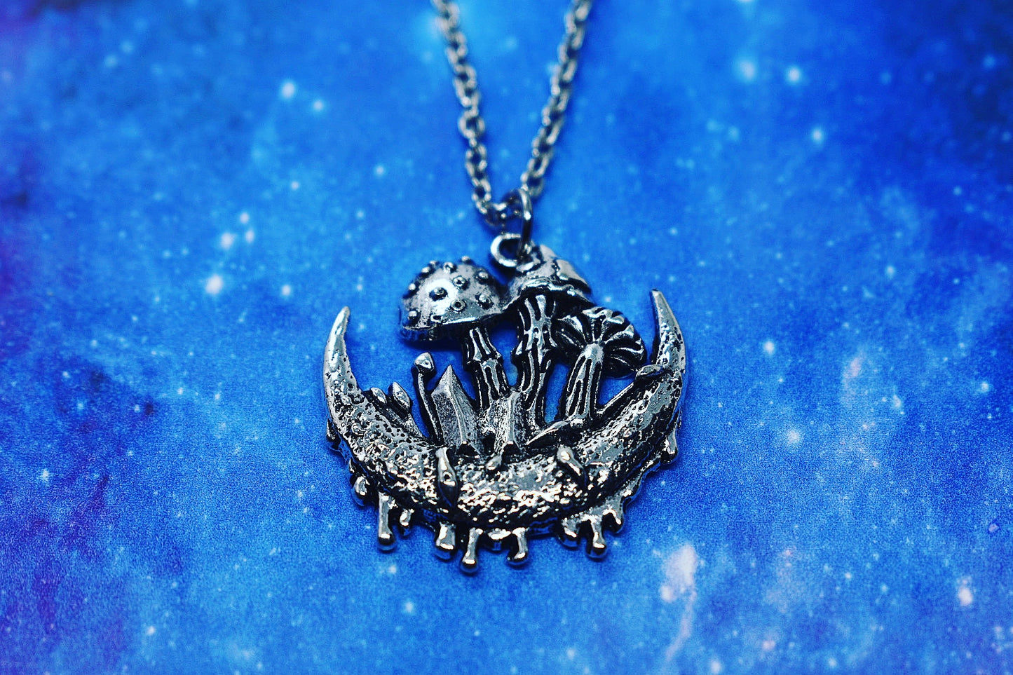 Necklace with crescent moon, mushroom and crystal pendant