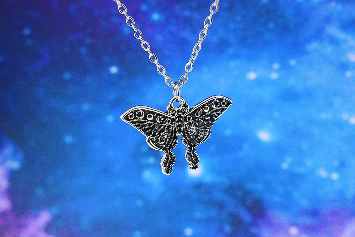 Moth pendant with triple moon symbol
