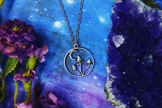 Necklace with mushroom and crescent moon pendant